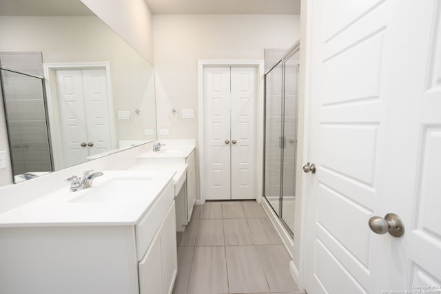 bathroom with tile patterned flooring, vanity, and an enclosed shower