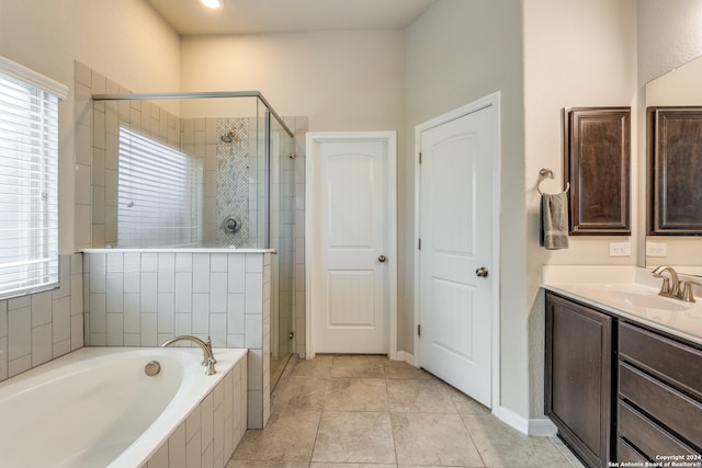 bathroom with separate shower and tub, plenty of natural light, and vanity