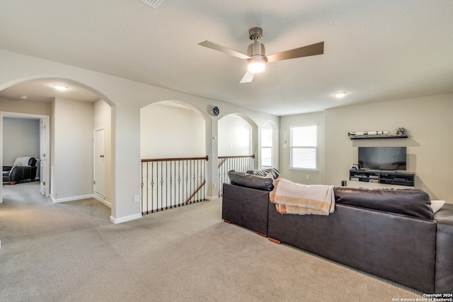 living room with light carpet and ceiling fan