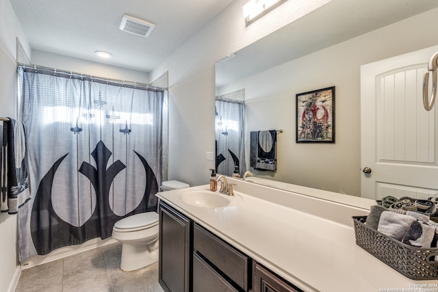 bathroom featuring tile patterned flooring, vanity, a shower with shower curtain, and toilet