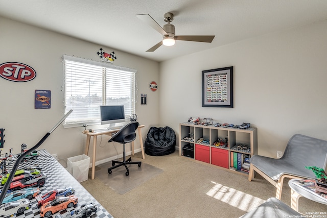 carpeted office featuring ceiling fan