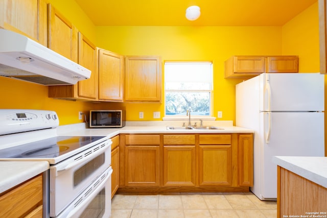 kitchen with sink, light tile patterned floors, and white appliances