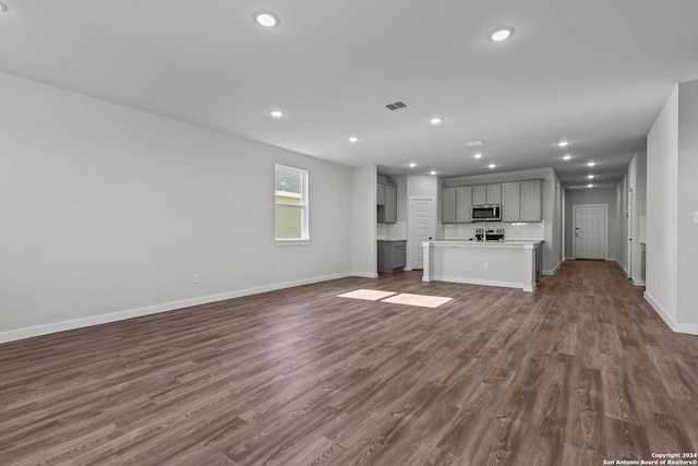 unfurnished living room featuring dark wood-type flooring