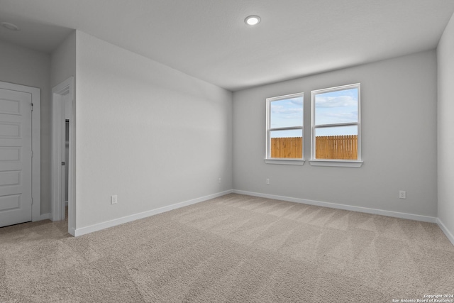 unfurnished room with light colored carpet