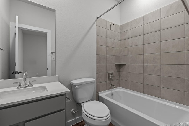 full bathroom with vanity, tiled shower / bath combo, and toilet