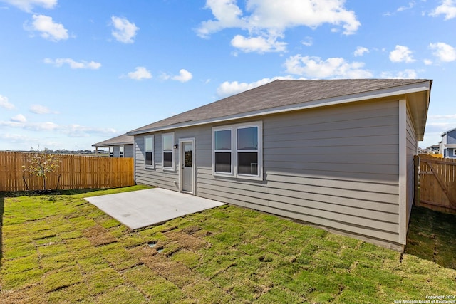 rear view of house with a patio area and a yard