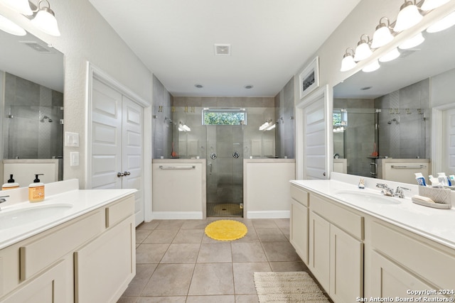 bathroom featuring tile patterned flooring, vanity, and an enclosed shower