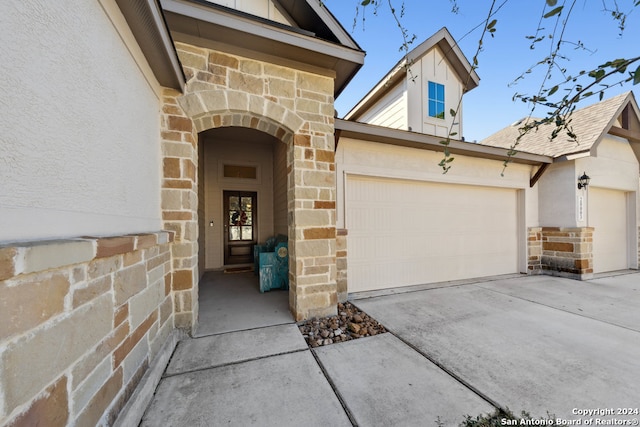 view of exterior entry featuring a garage