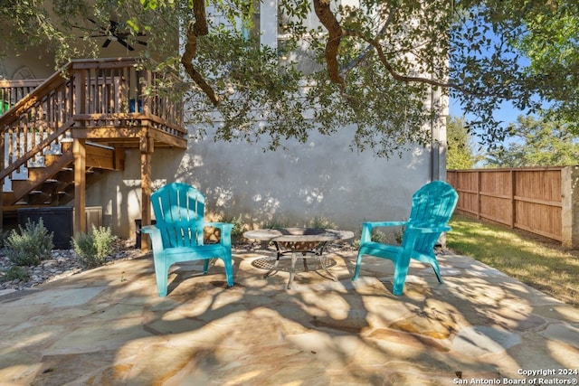 view of patio / terrace with ceiling fan and a deck