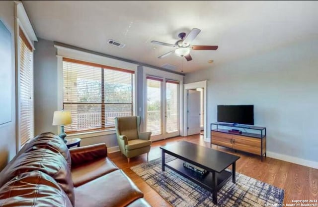 living room featuring ceiling fan and wood-type flooring