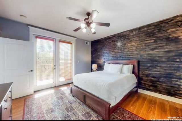 bedroom with light wood-type flooring, access to outside, and ceiling fan