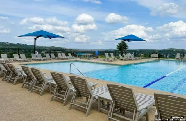 view of swimming pool with a patio area