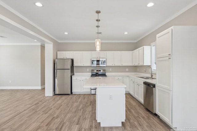 kitchen with white cabinetry, sink, a center island, and stainless steel appliances