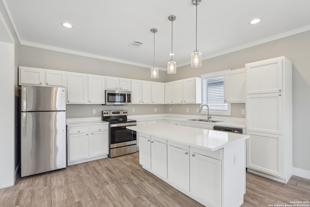 kitchen with white cabinetry, sink, stainless steel appliances, light hardwood / wood-style flooring, and pendant lighting