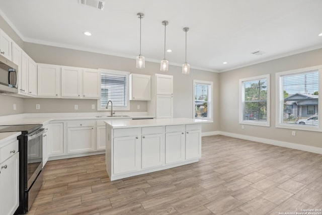 kitchen with white cabinetry, sink, light hardwood / wood-style flooring, black electric range oven, and pendant lighting