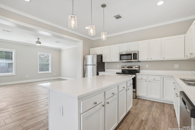 kitchen featuring light wood-type flooring, stainless steel appliances, ceiling fan, crown molding, and white cabinetry