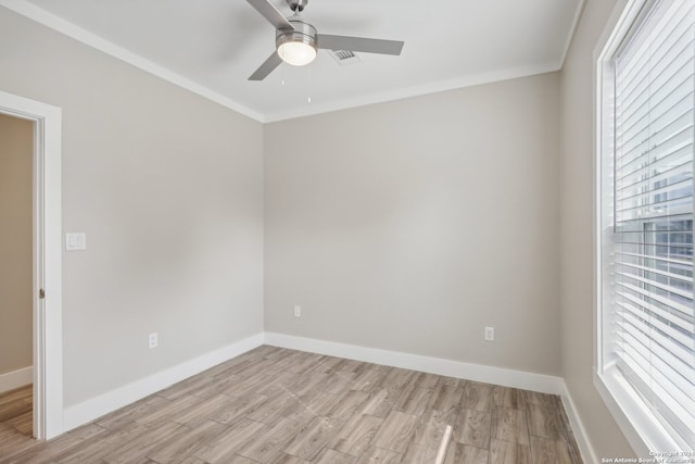 spare room with light wood-type flooring, ceiling fan, and ornamental molding