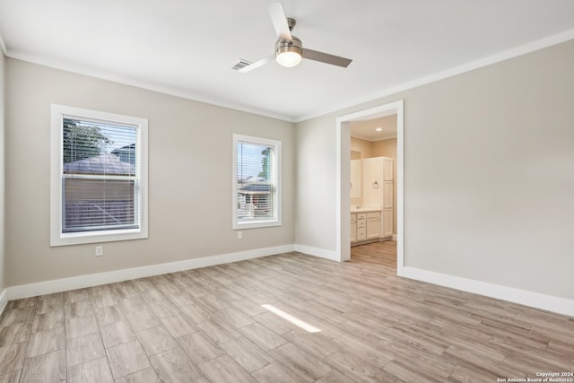 unfurnished bedroom with ceiling fan, crown molding, connected bathroom, and light hardwood / wood-style flooring