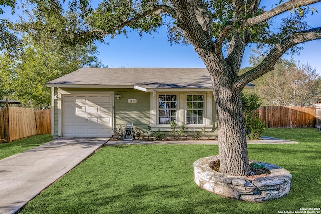 ranch-style home with a garage and a front yard