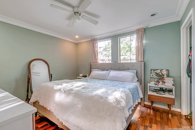 bedroom featuring dark hardwood / wood-style flooring, ceiling fan, and crown molding