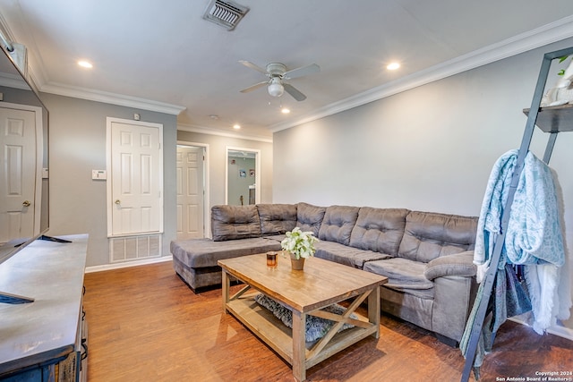 living room with hardwood / wood-style flooring, ceiling fan, and crown molding