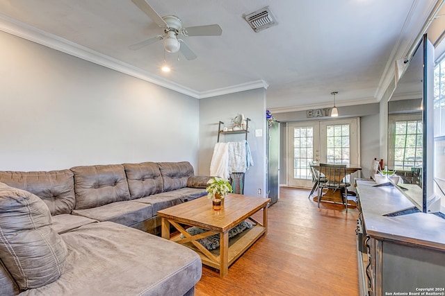 living room featuring french doors, light hardwood / wood-style flooring, ceiling fan, and crown molding