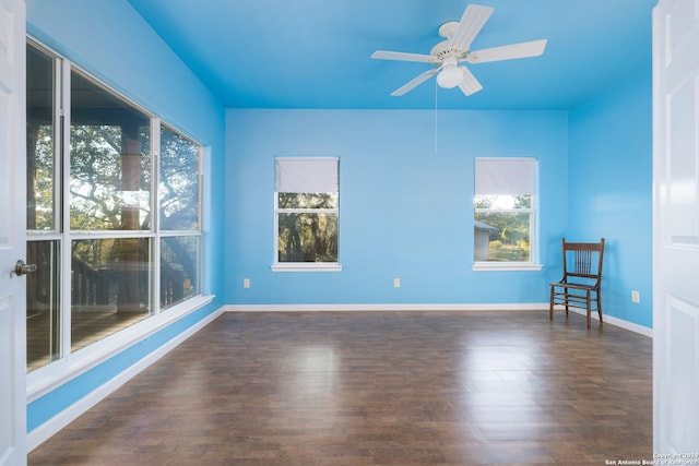 spare room featuring ceiling fan and dark wood-type flooring