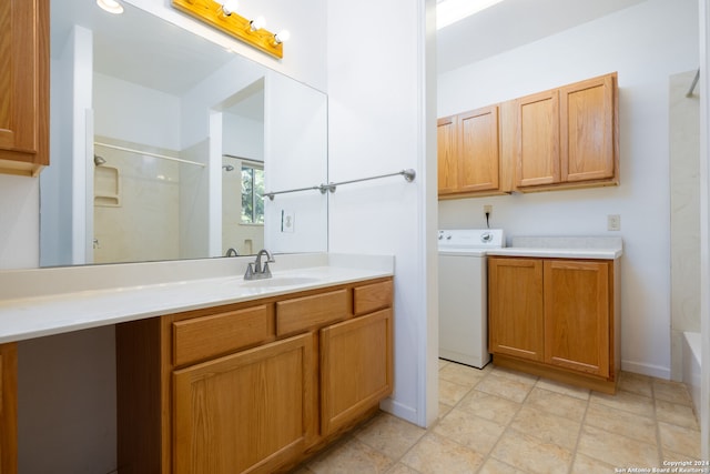 bathroom featuring vanity and washer / clothes dryer