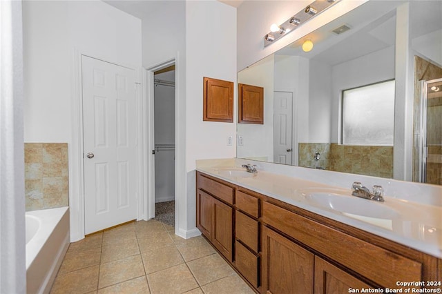 bathroom with tile patterned floors, vanity, and a bathing tub