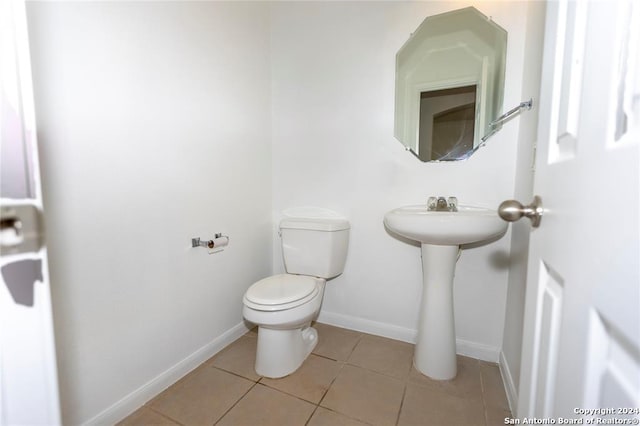 bathroom featuring tile patterned flooring, toilet, and sink