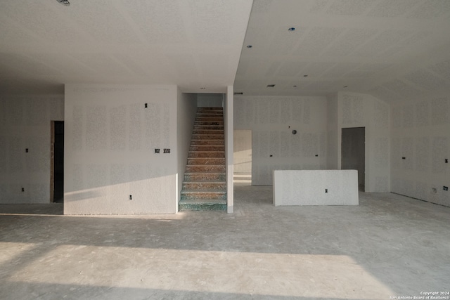 6727 Tasajillo Spg, San Antonio, TX 78253 - unfurnished living room featuring stairway and unfinished concrete flooring