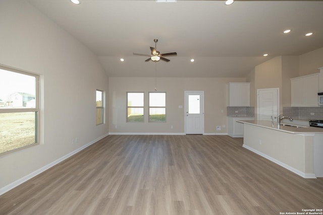 6727 Tasajillo Spg, San Antonio, TX 78253 - unfurnished living room with vaulted ceiling, light wood finished floors, recessed lighting, a ceiling fan, and baseboards