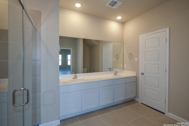 6727 Tasajillo Spg, San Antonio, TX 78253 - bathroom featuring toilet, double vanity, a shower stall, tile patterned flooring, and baseboards