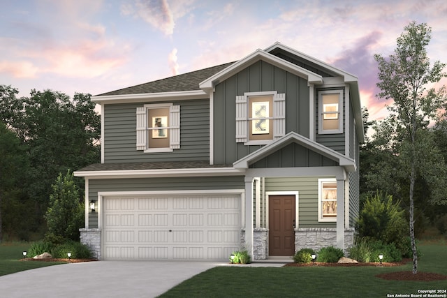 craftsman house with a lawn and a garage