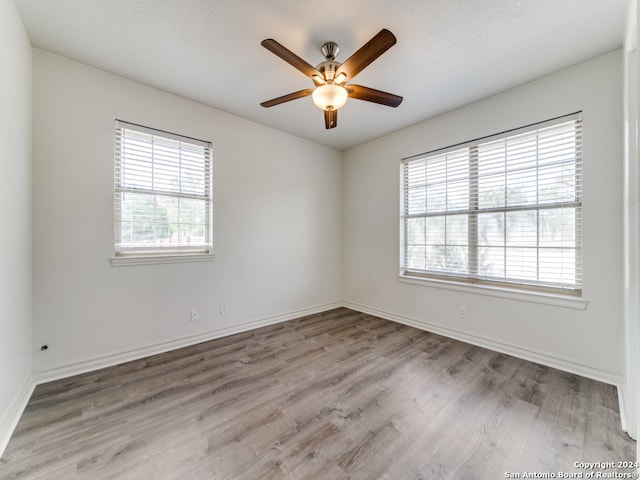 unfurnished room featuring light wood-type flooring and ceiling fan