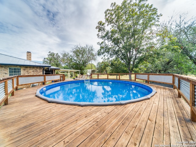 view of swimming pool featuring a wooden deck