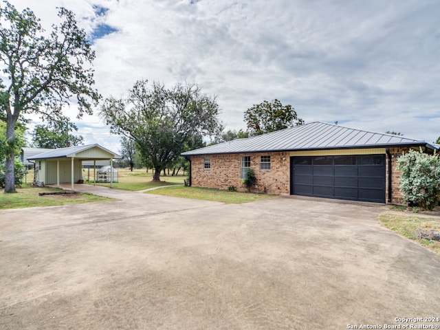 view of front of house with a garage and a front lawn