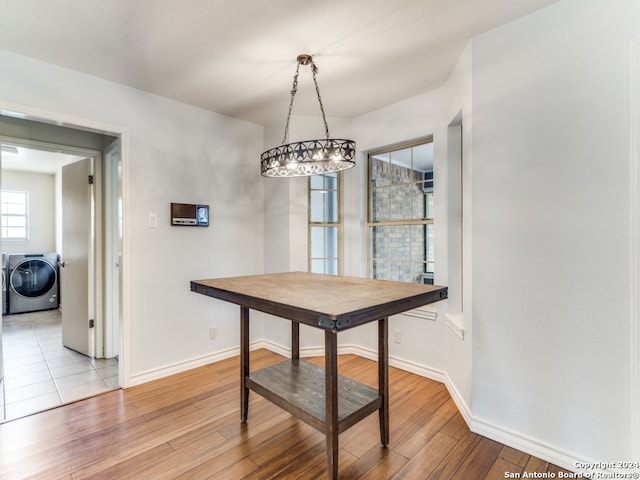 dining space featuring washer / clothes dryer and light hardwood / wood-style floors