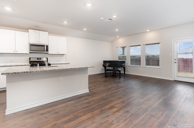 kitchen with a kitchen island with sink, appliances with stainless steel finishes, and dark wood-type flooring