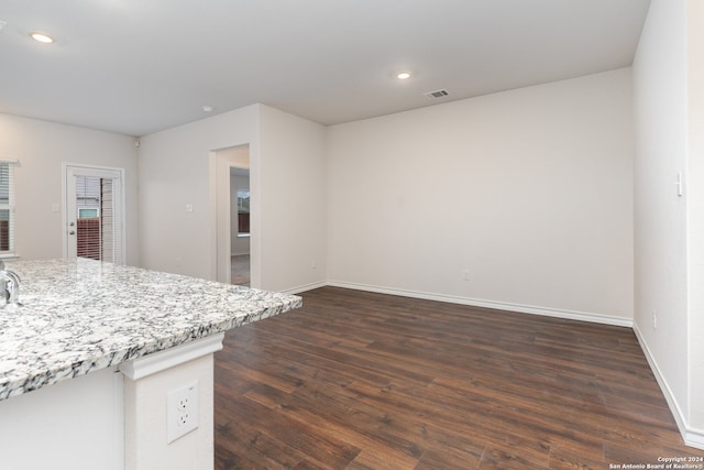 kitchen with light stone countertops and dark hardwood / wood-style floors