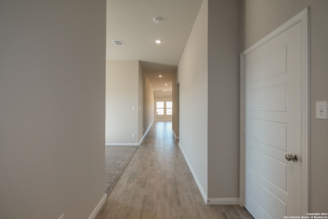 hallway with light hardwood / wood-style flooring