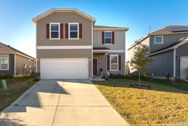 front of property featuring a front yard and a garage