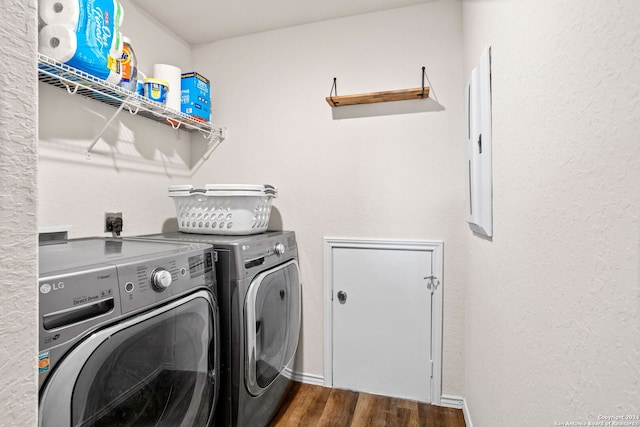 clothes washing area featuring dark hardwood / wood-style flooring and independent washer and dryer