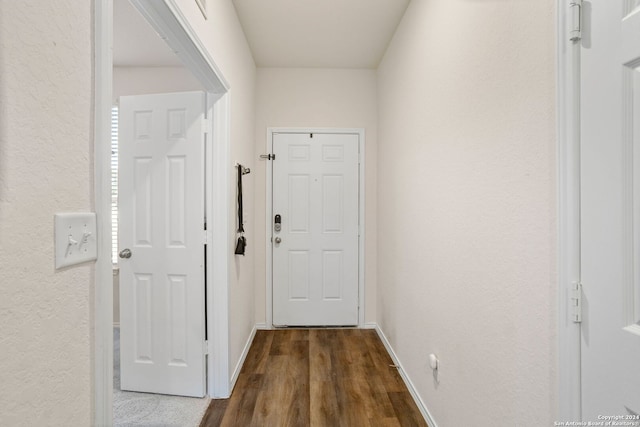 corridor with dark hardwood / wood-style flooring