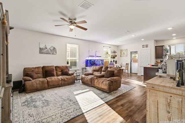 living room featuring dark hardwood / wood-style flooring and ceiling fan