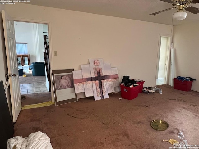 bedroom with ceiling fan and dark colored carpet