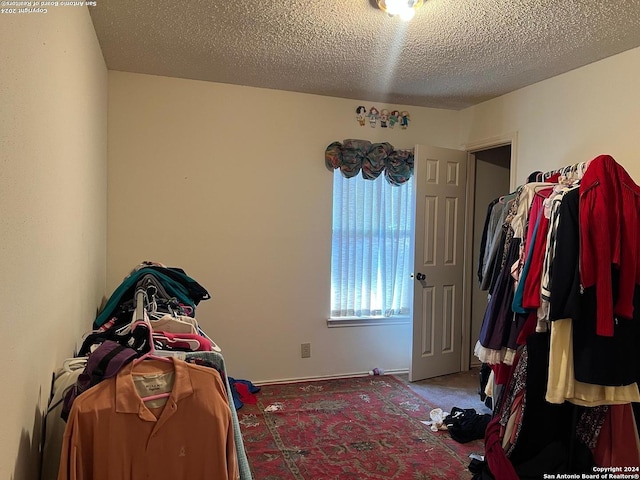 carpeted bedroom featuring a textured ceiling