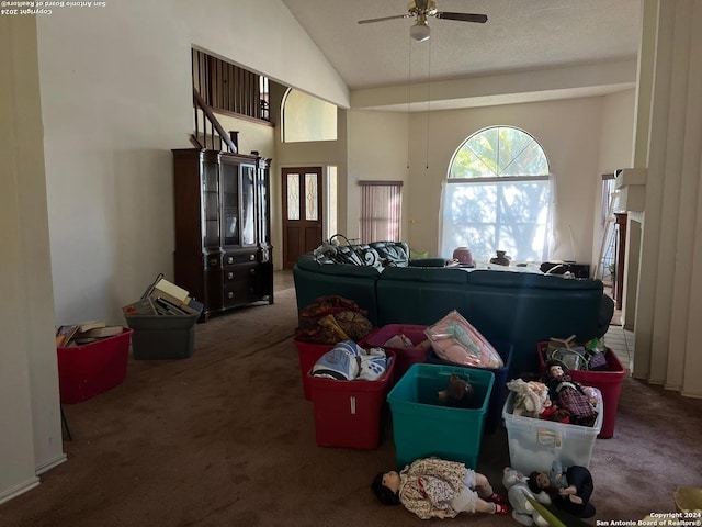 living room featuring dark colored carpet, ceiling fan, and vaulted ceiling