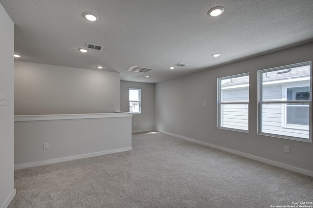 4750 Sahara Vlys, San Antonio, TX 78222 - carpeted spare room featuring a textured ceiling, recessed lighting, and baseboards