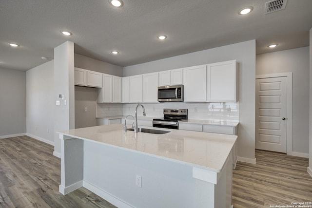 4750 Sahara Vlys, San Antonio, TX 78222 - kitchen with stainless steel appliances, a sink, baseboards, backsplash, and recessed lighting